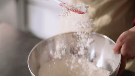 unrecognizable girl in apron mixing ingredients for pastry