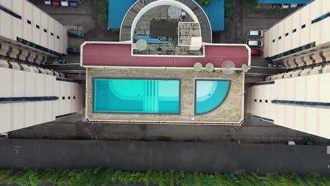 aerial view of apartment building with rooftop swimming pool