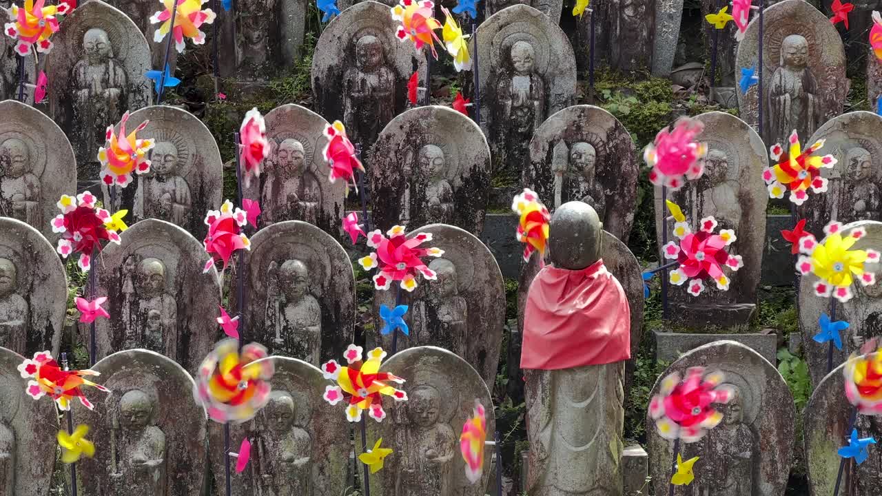 Close up of Jizo Statues at Japanese temple waving in wind