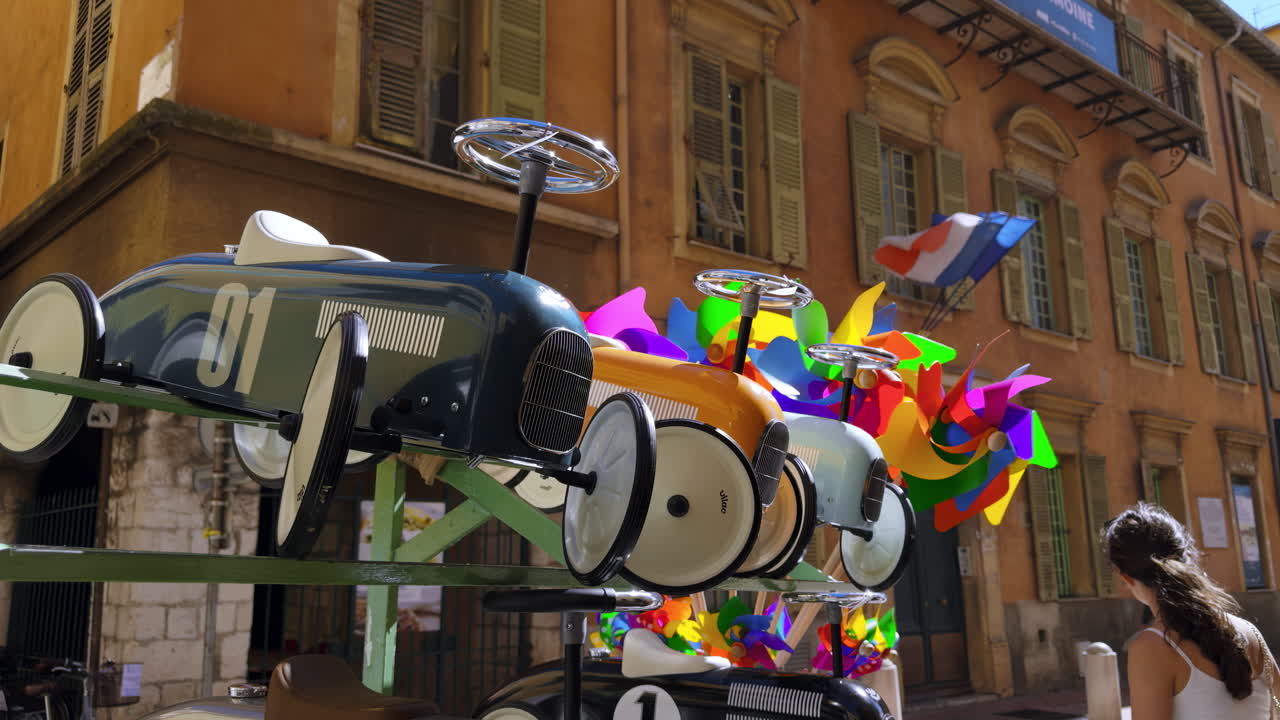 Vintage Toy Cars and Windmills on Display in a European City Street