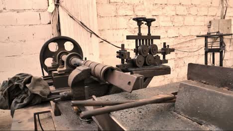 vintage rusty lathe in factory workshop. dolly back