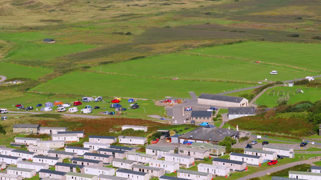 Holiday Park with Static Caravans and Camping with Sand Dunes Landscape and Sea Estuary Background 4K