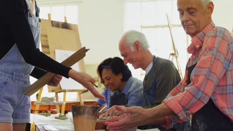 woman assisting artists in pottery 4k