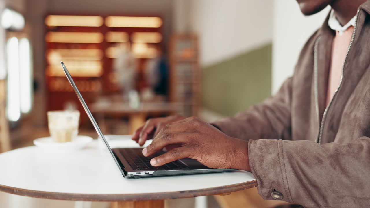Man working on laptop in cafe