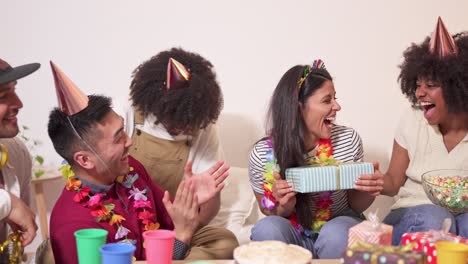 diverse group of friends celebrating a birthday party with gifts