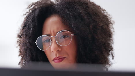 Serious-woman,-glasses-and-face-reading-laptop