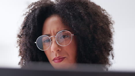 serious woman, glasses and face reading laptop