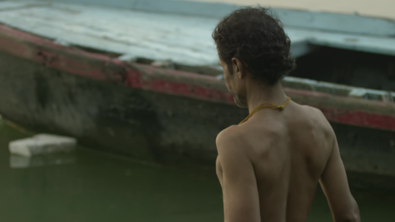 A man walks past a boat