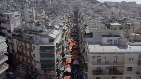 aerial drone shot along street market athens greece panning down