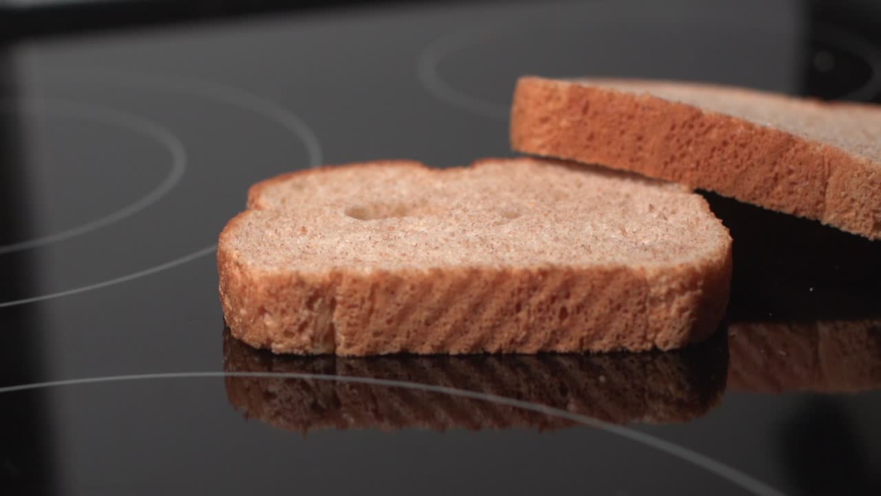 Bread slices against black background falling in slow motion