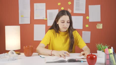 The-girl-child-is-studying-at-home,-solving-questions.