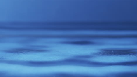 video of close up of drops of water with copy space on blue background