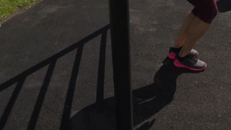 Sporty-Caucasian-woman-exercising-in-an-outdoor-gym-during-daytime