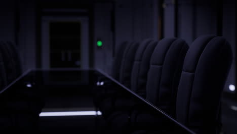 conference room with dark lighting and empty chairs ready for meeting