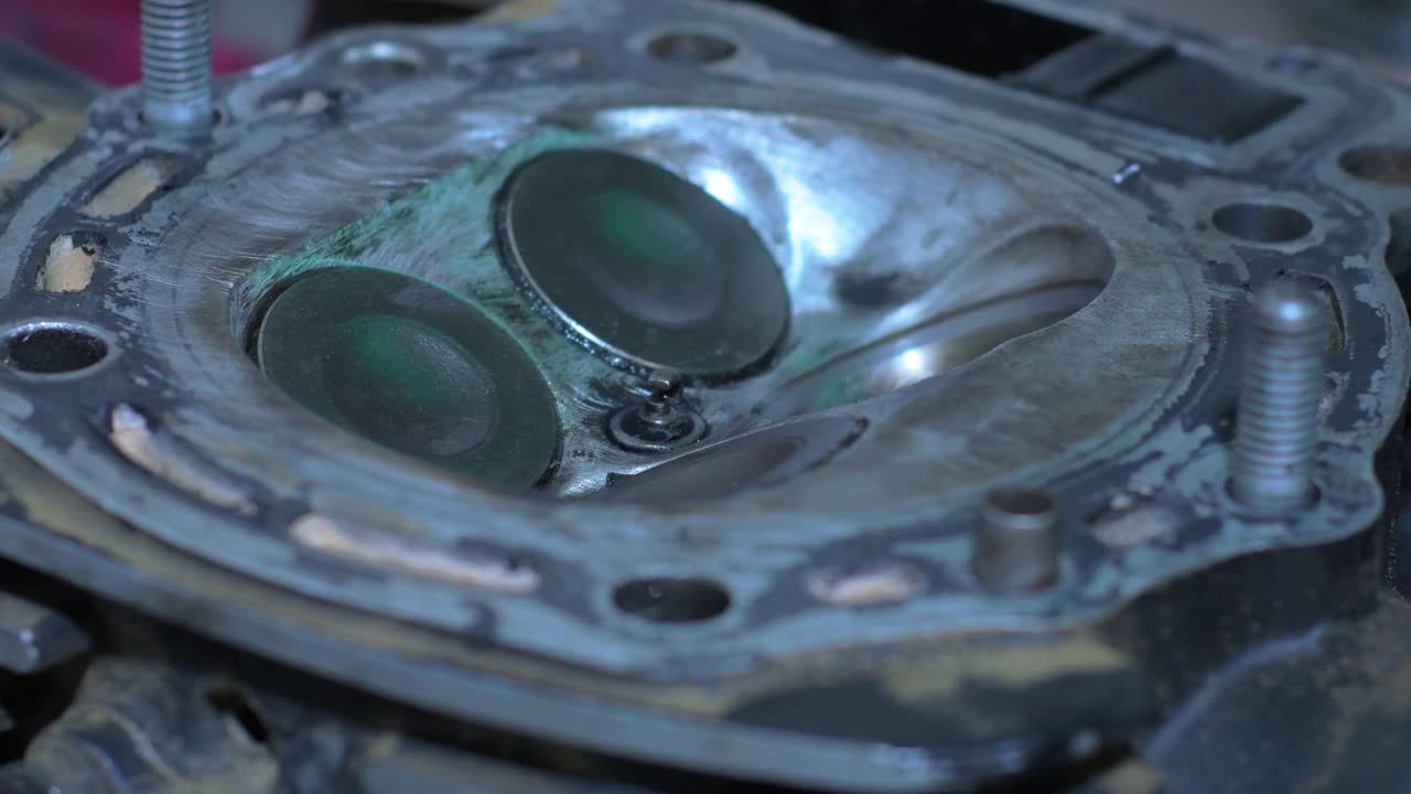 Static insert shot hands-on mechanical restoration process, gritty texture and precise components of the cylinder head