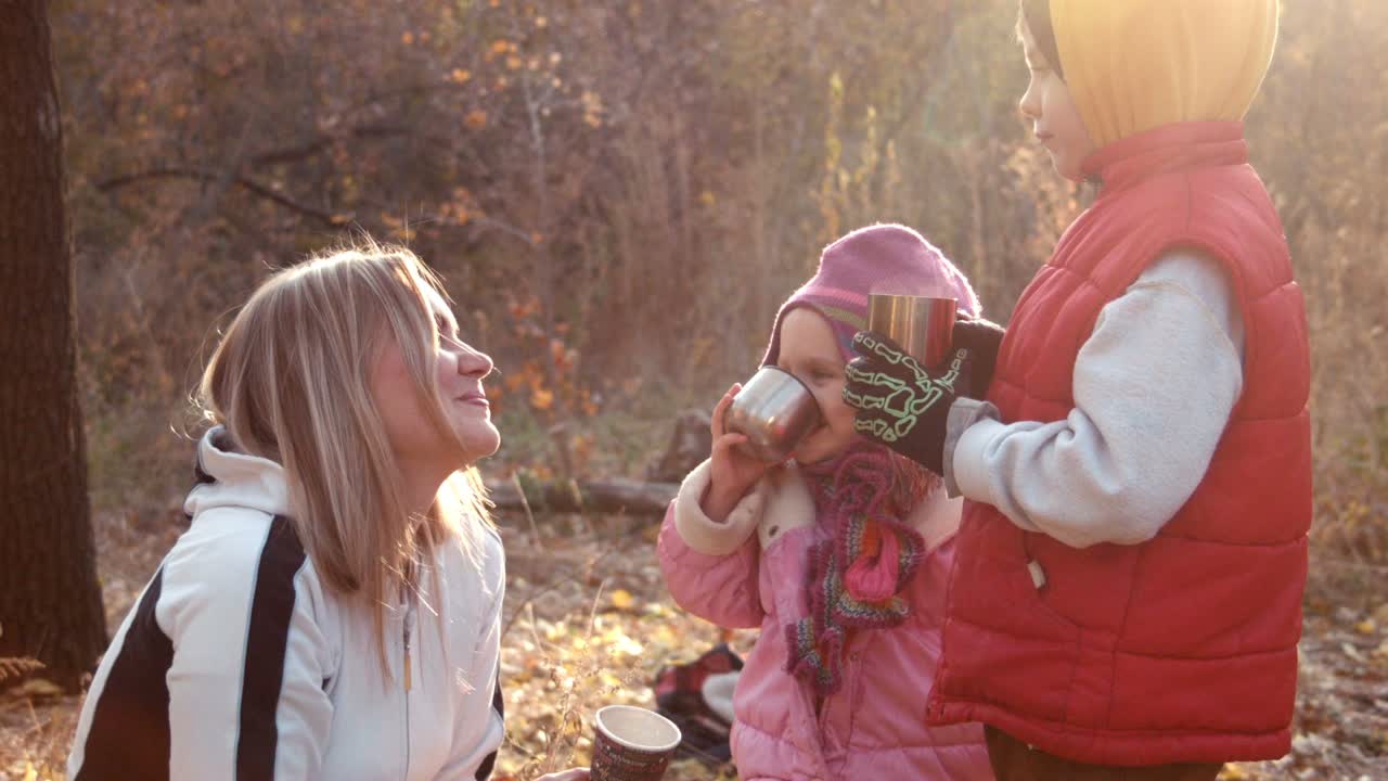 The Family Drink Tea or Coffee In Autumn Park