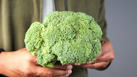 person holding broccoli