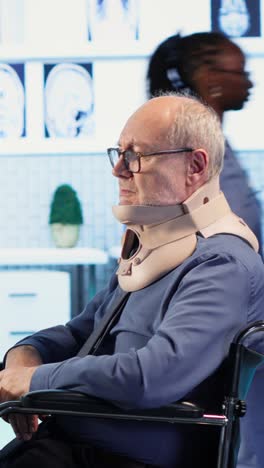 Vertical Video Physician consulting man with chronic impairment and neck injury