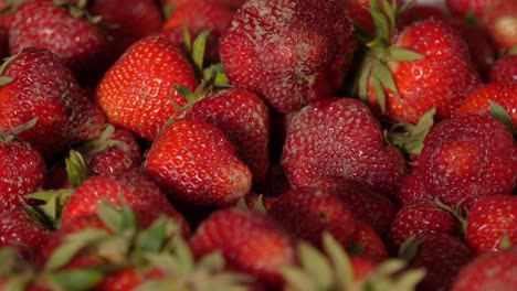 freshly harvested strawberry falling on a pile of strawberries - 180 fps slow motion