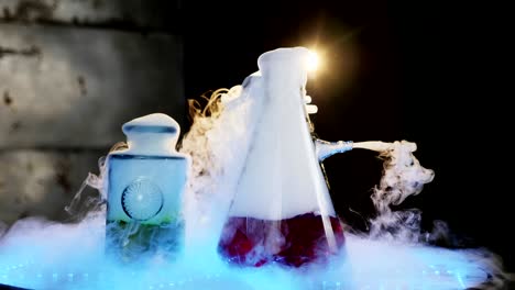 two glass flasks on the table with illumination