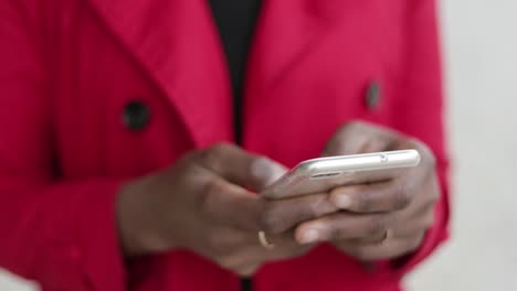 Close-up-shot-of-Afro-american-female-hands-texting-on-phone