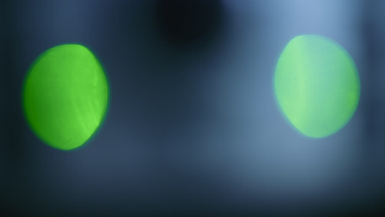Abstract out of focus green and red lights forming soft circular bokeh shapes