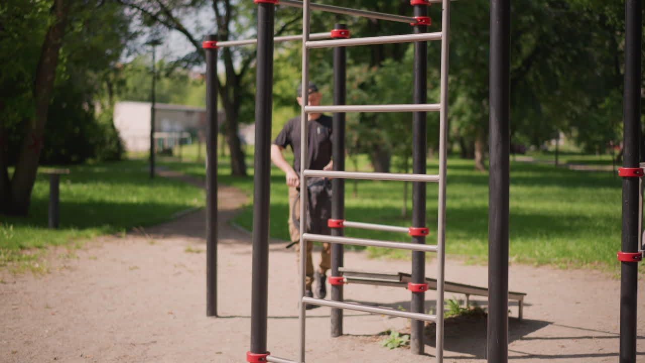 Calisthenics Bars Closeup With White Man In Background, Steel Frame, Ladder Rungs, Textured Paint And Bolts, Outdoor Gym Station, Sunny Park, Detail Shots Of Grip And Hardware, Urban Workout Setting