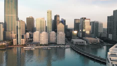 Aerial-view-of-Downtown-Miami-urban-city-center-south-of-the-Miami-River-Brickell-at-sunrise,-slow-motion