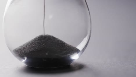 Video-of-hourglass-with-sand-pouring,-copy-space-on-white-background