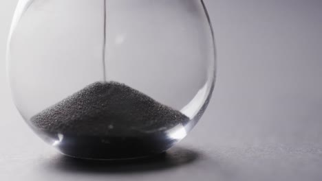 video of hourglass with sand pouring, copy space on white background