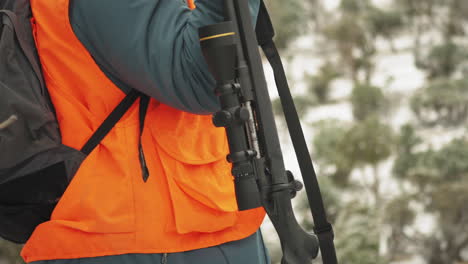 hunter preparing for hunting trip by taking his rifle with him