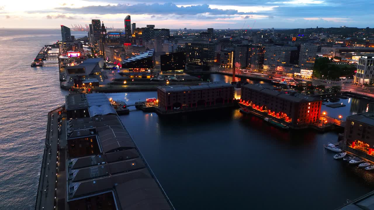 Aerial view of Liverpool's historic docks and cityscape glowing at dusk, showcasing the vibrant Merseyside maritime heritage. Circle Dolly