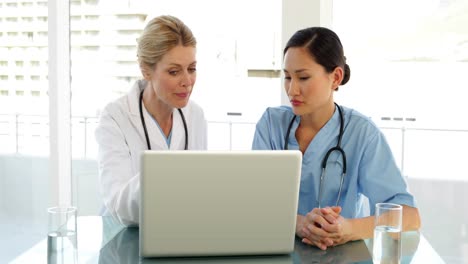 Doctor-and-nurse-going-over-a-file-on-the-laptop