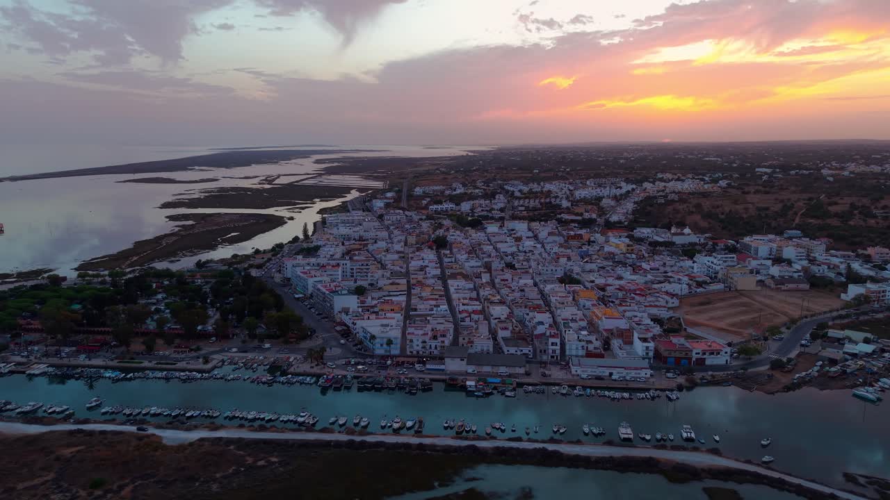 aerial panoramic shot around Fuseta fishing village at sunset, near ria formosa natural reserve on the Algarve Coast near Faro, Portugal