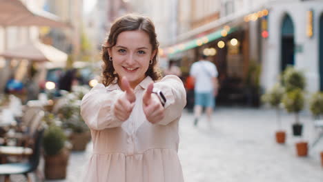 young woman showing thumbs up like sign positive something good positive feedback in city street
