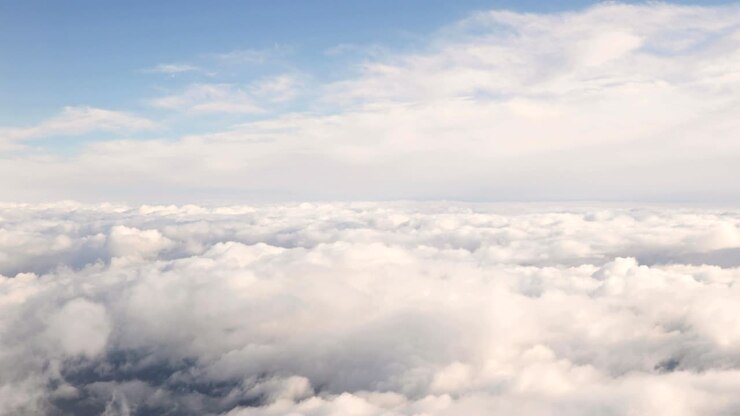Beautiful Aerial View Of Clear Sky Over White Fluffy Clouds From Height Flight Of Plane
