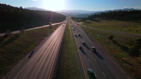 i70 interstate cars traffic trucks buffalo evergreen aerial drone idaho springs summer sunlight sunset golden canyon indian peaks genesse park mountain layers rocky mountains colorado usa forward