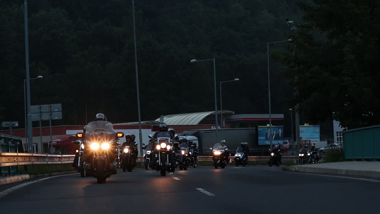 Cinematic slow motion rolling shot of motorcyclists on freeway in evening, Slovakia