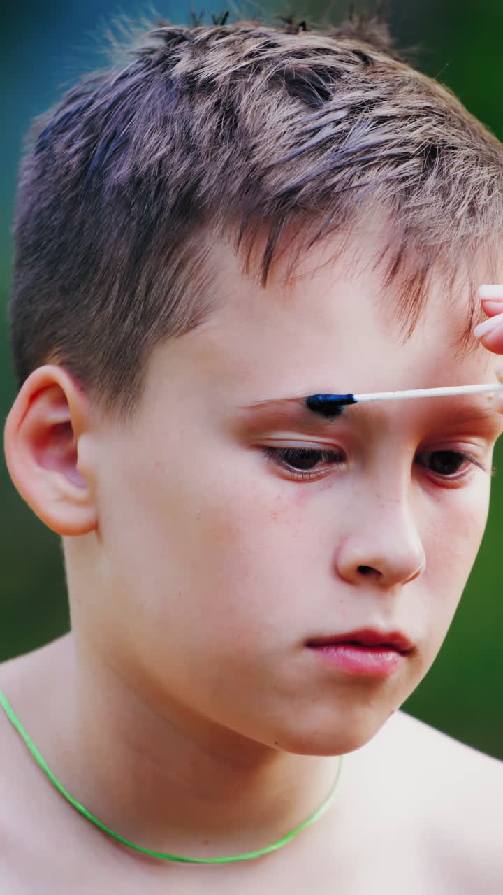 Boy with paint on his forehead