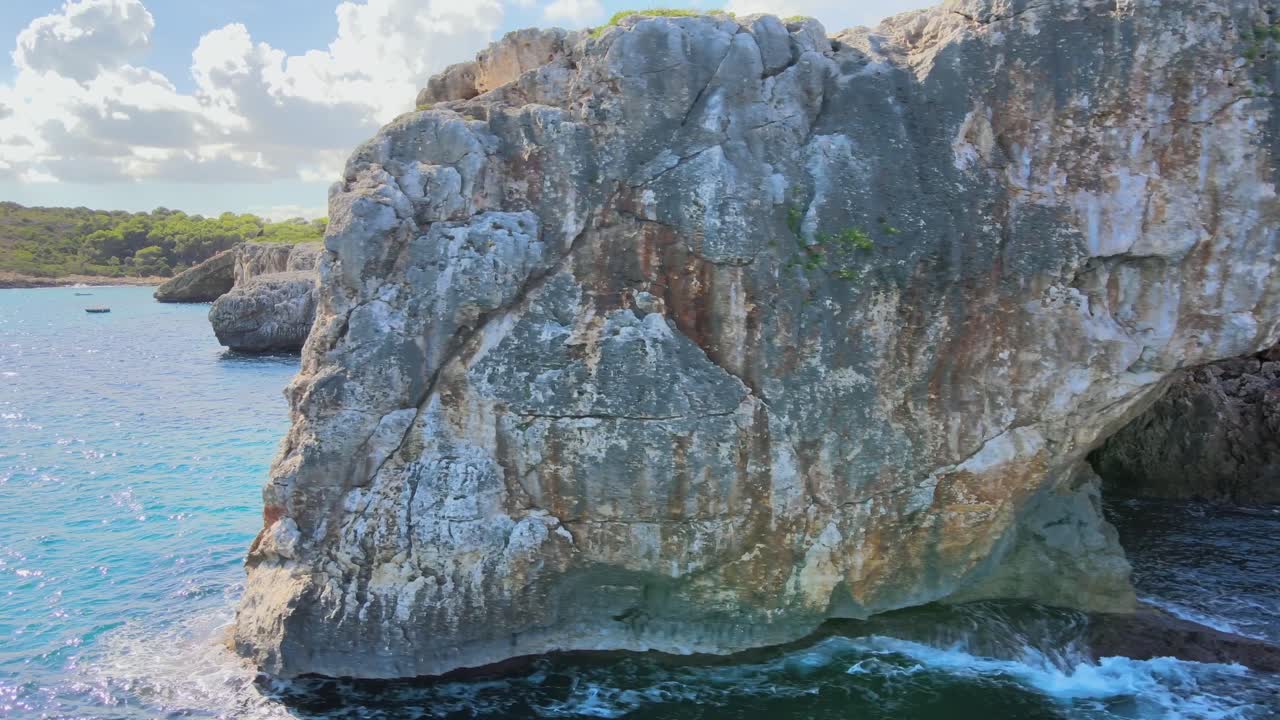 Explore the stunning coastal views of Cala Varques near Porto Cristo, Majorca. The turquoise waters and majestic cliffs create a picturesque paradise perfect for adventure.