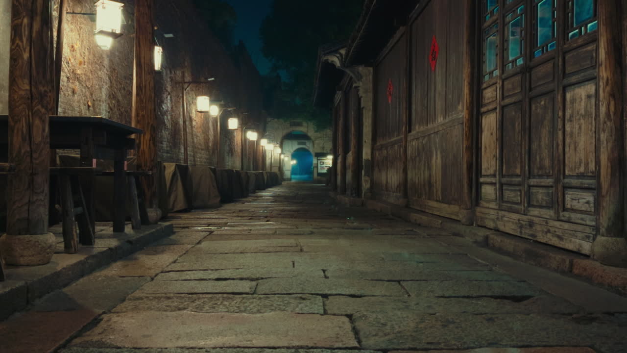 Ancient stone path in Wuzhen, China, illuminated by lanterns at night