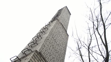 tilt shift of an old industrial smokestacks based in jelgava, latvia where some trees are grown