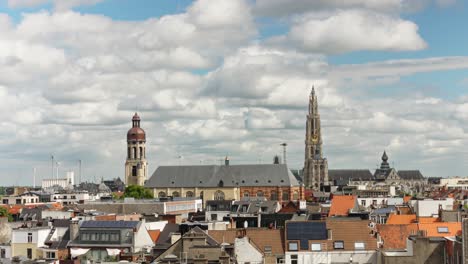 timelapse of antwerp skyline featuring the cathedral and st. andrew’s church under moving clouds
