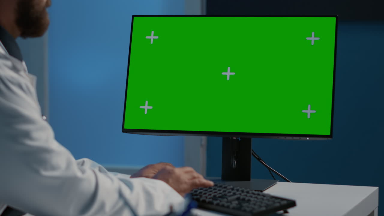 Doctor using computer with green screen
