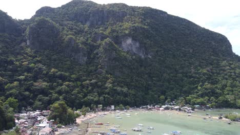 El-Nido-town-proper-and-port-beachfront-pier-in-Bacuit-Bay,-Philippines