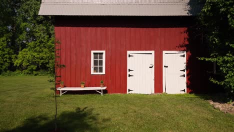 panning-medium-tight-shot-of-an-old-red-and-white-barn-on-a-sunny-day