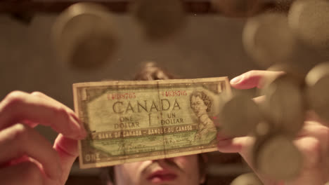 person holding a vintage canadian one-dollar bill