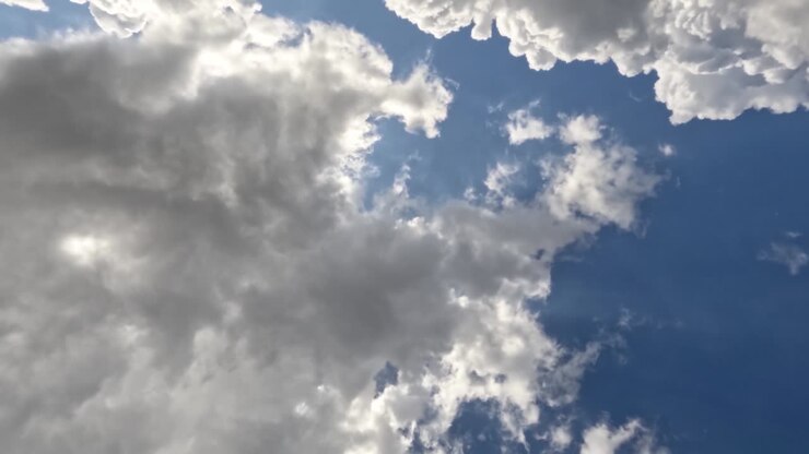 Time lapse of the movement of white clouds in a blue sky, weather changing from sunny to slightly cloudy