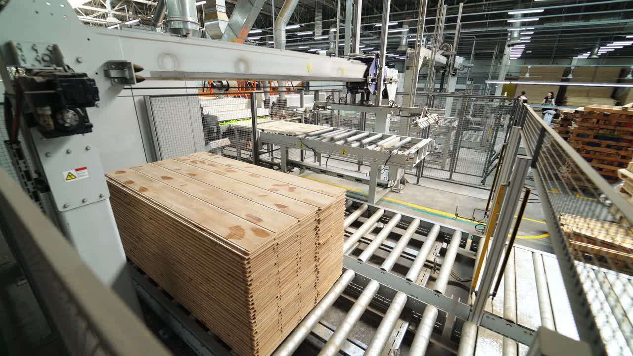 Floorboard production in the industrial factory. Manufacturing of a parquet board. Modern technologies.