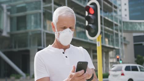 caucasian man out and about in the street wearing on a face mask against coronavirus